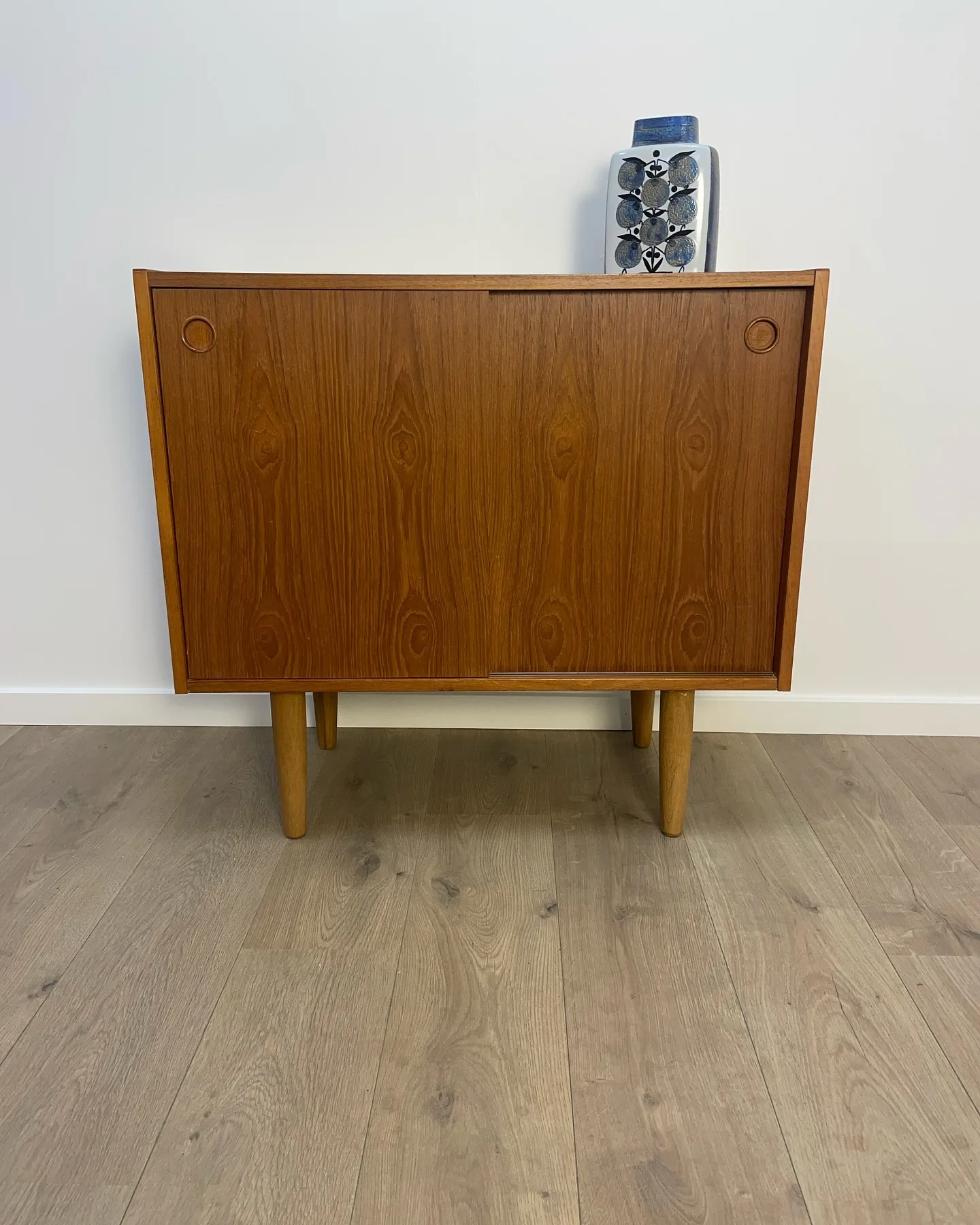 Teak skænk.

2 skydelåger hvor bag hylde.
Runde tilspidsede ben.
Dansk 60’erne.

B 80 D 4…